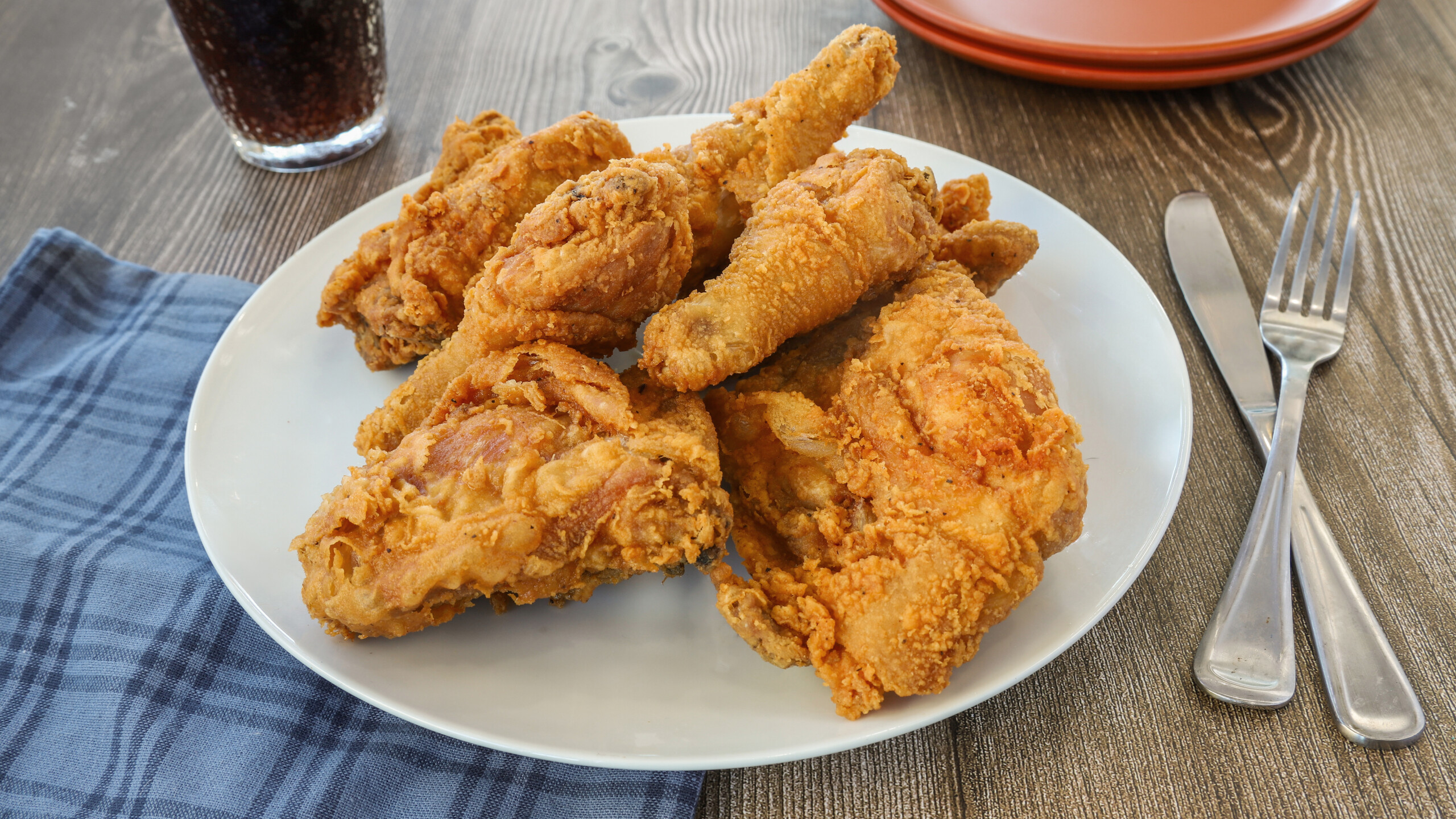 Golden bone-in fried chicken pieces on a white plate, pictured on Boston Fried Chicken & Burritos’ 95 Montello Street menu
